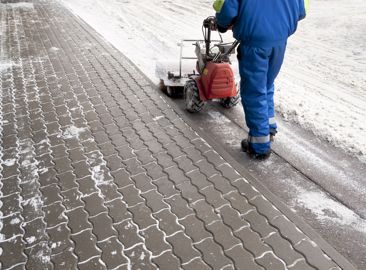 Man working with a snow blowing machine