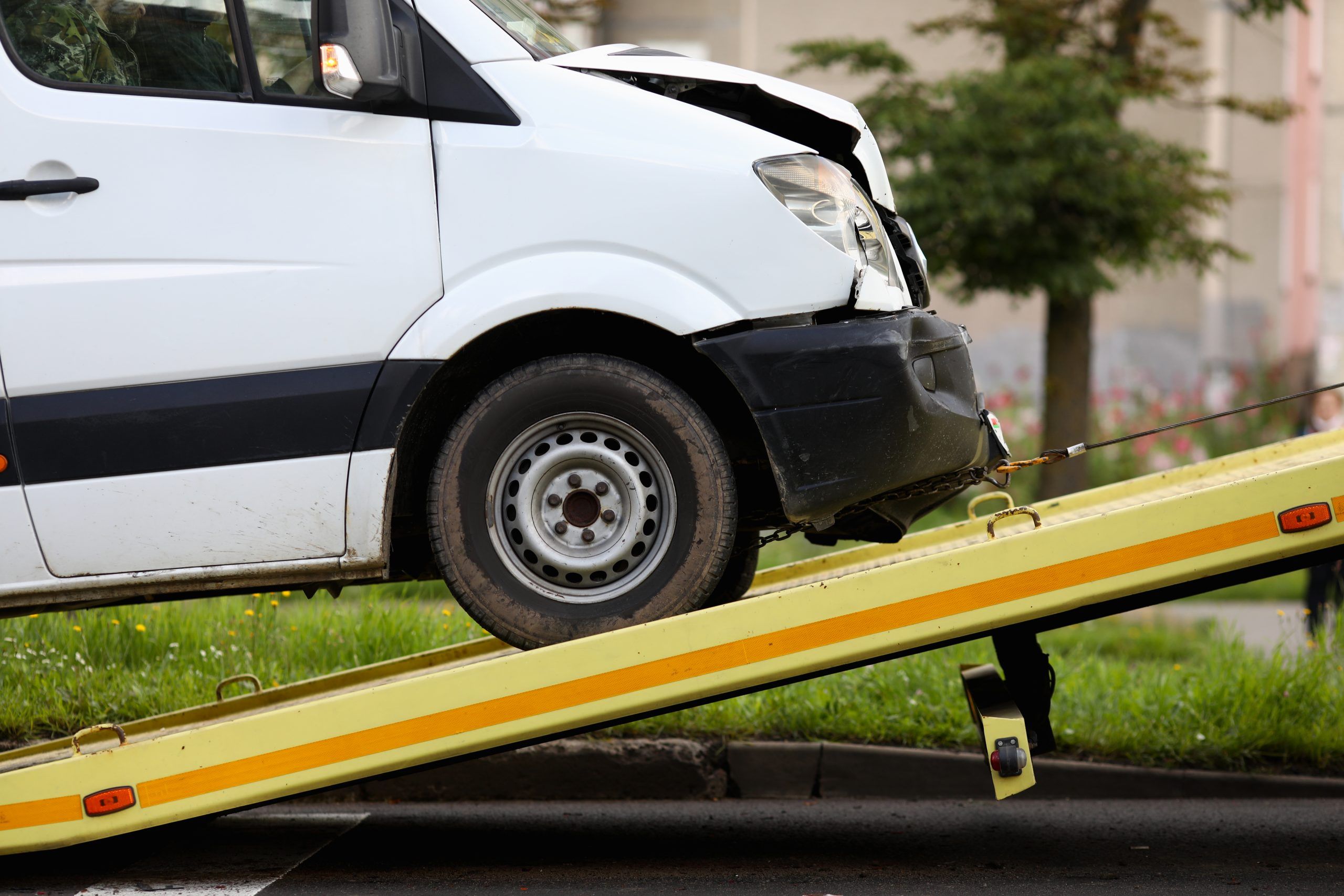 crashed van being winched onto a repair truck